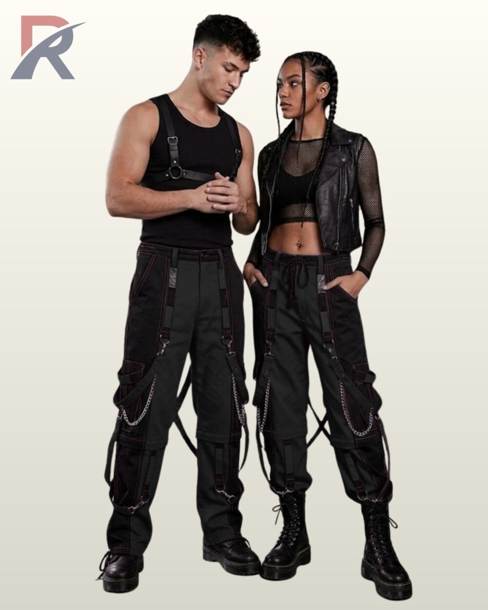 Couples catalog shot of monochromatic black and dark grey cyberpunk raver cargo trousers featuring hanging D-ring straps, side chains, and combat boots.