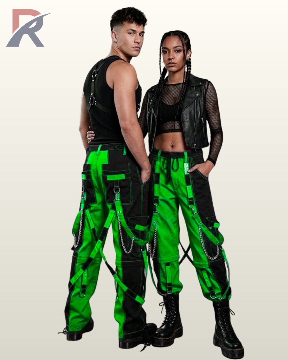 Full model view of a male and female wearing black and toxic neon green two-tone gothic bondage cargo pants with hanging silver chains and buckle straps.