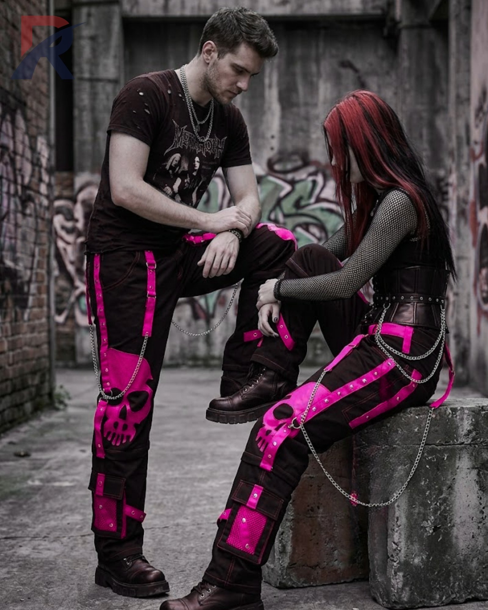 Loose black gothic cargo pants accented with a hot pink skull graphic and silver chains.