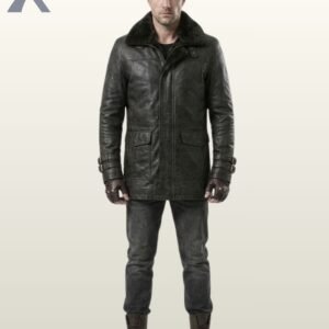 man standing full-length in a black leather double-breasted peacoat with a black fur collar.