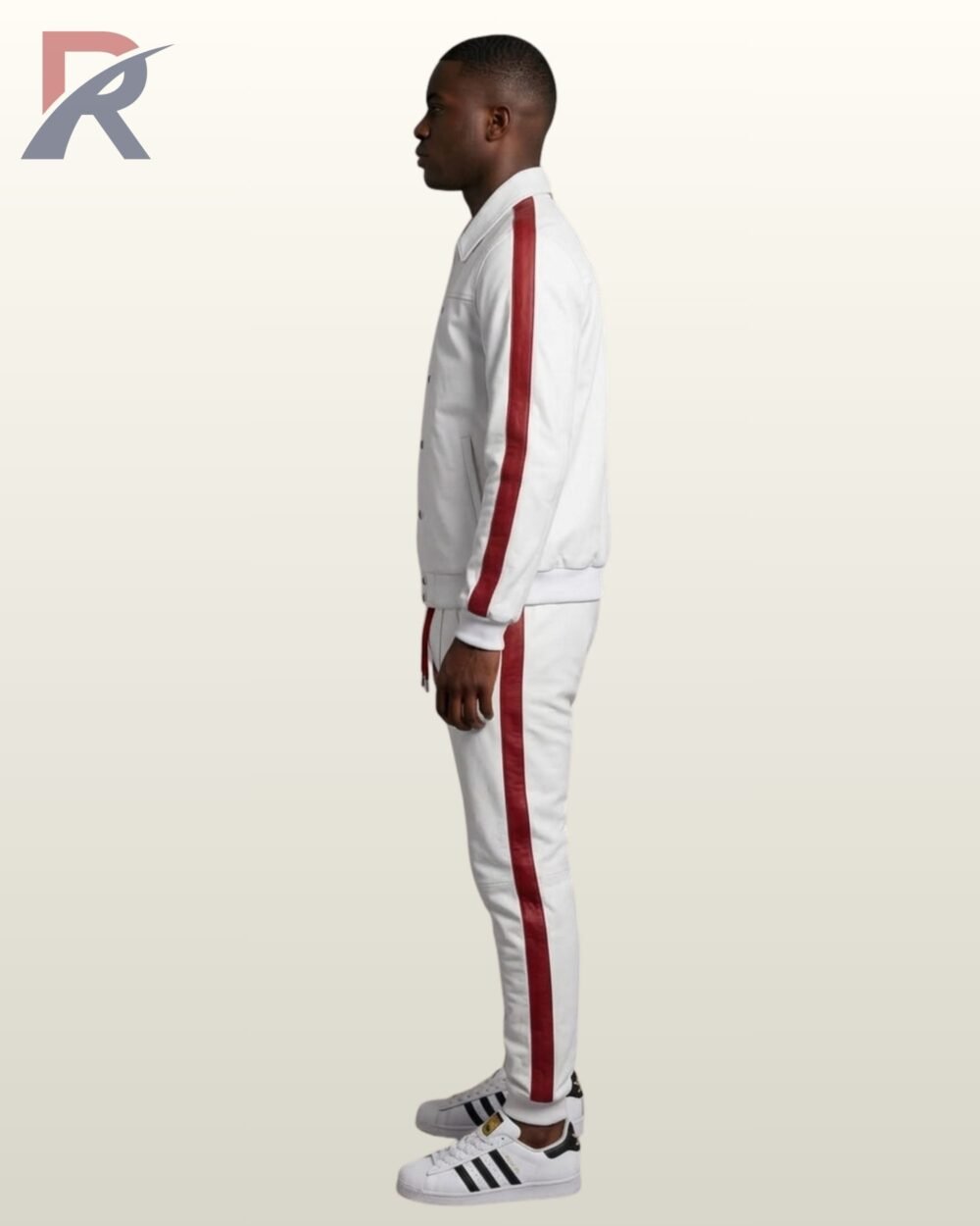 A model showcasing a high-end white athleisure jogger set featuring a structured jacket and slim-fit sweatpants with red side panels.