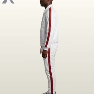 A model showcasing a high-end white athleisure jogger set featuring a structured jacket and slim-fit sweatpants with red side panels.
