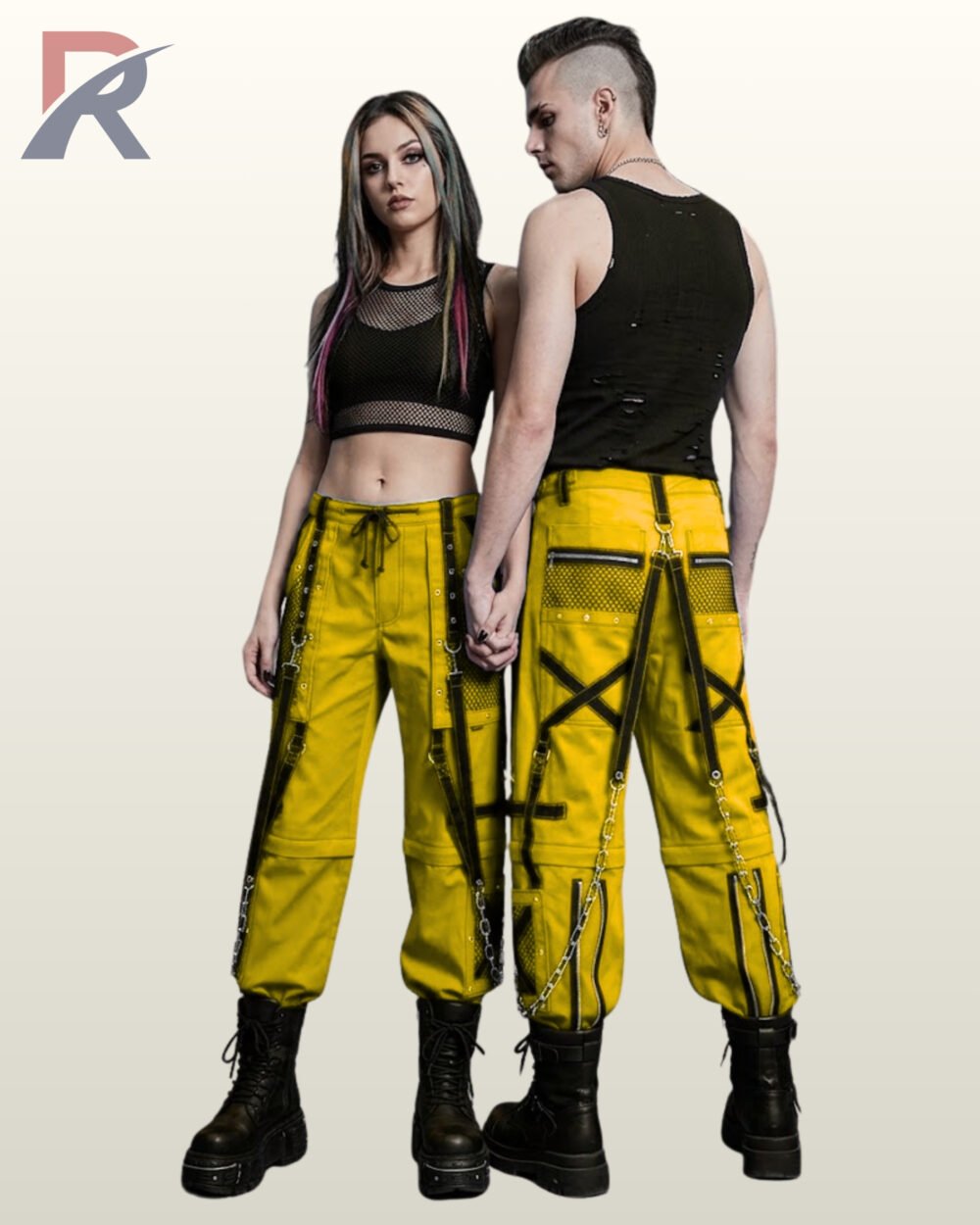 Couple wearing vibrant yellow gothic cargo bondage pants with black mesh pockets, cross straps, and metal chains.