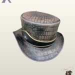 Three-quarter front profile of a brown crocodile embossed leather steampunk top hat featuring a black leather hatband with brass gold piping.
