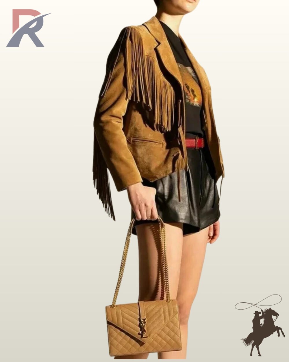 Three-quarter side view of a model wearing a camel tan suede western fringe jacket styled with black shorts and a beige chain handbag.