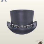 Gothic victorian style black leather top hat displaying a flat crown top, upturned side brims, and polished silver skull hardware.