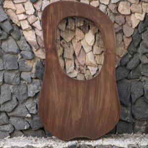 Back side of a solid wooden lyre harp showing smooth dark brown finish, natural wood grain, and upper open sound cavity.