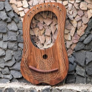 Full front view of a 10-string handcrafted wooden lyre harp featuring white engraved Celtic knotwork border and sound hole design.