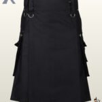 Front view of a men's plain black gothic utility kilt featuring a flat apron, waistband D-rings, and side cargo pockets.
