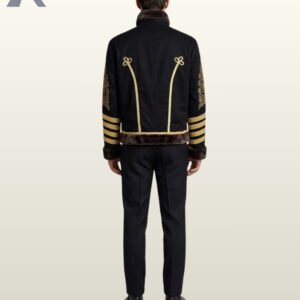 Full rear view of a model wearing a men's black military hussar jacket featuring dark fur collar trim, gold piping with trefoil loops, and gold sleeve stripes.