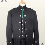 Traditional Scottish black wool Sheriffmuir jacket and vest combination paired with a tartan kilt and green necktie.