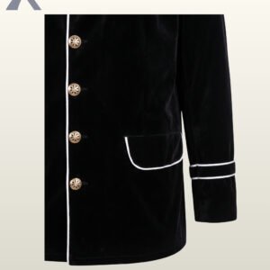 Close-up front product view of a men's black velvet military jacket showing white contrast piping edges, filigree brass buttons, flap pockets, and double sleeve braid.