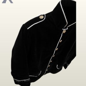 Angled top-down detail shot of a men's black velvet military officer jacket highlighting the standing collar, white contrast piping, and buttoned shoulder epaulet.