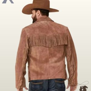 Rear view of a model in a brown cowboy hat wearing a men's cognac suede western jacket with a fringed back yoke and sleeve tassels.