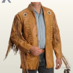 Front view of a model wearing a men's natural tan leather western fringe jacket featuring bone pipe bead chest detailing, sleeve tassels, and concho button closure.