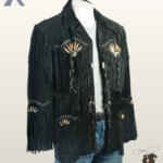 Three-quarter angle view of a men's black suede western jacket showcasing bone pipe beadwork, fringed patch pockets, long sleeve tassels, and black whipstitched accents.