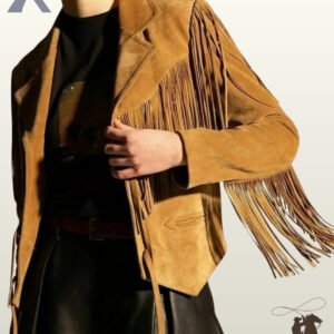 Front close-up view of a model wearing a camel tan suede western fringe jacket featuring tailored notched lapels, chest fringe, and arrow-stitched welt pockets.