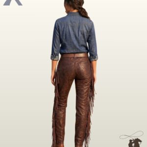 Full rear view of a model wearing women's distressed dark brown leather pants featuring back pockets, a brown leather belt, and side leg fringe.