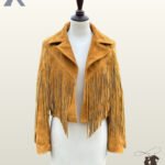 Women's ocher yellow suede cowgirl fringe jacket displayed on a mannequin with wide notch lapels and open front styling.