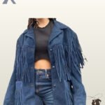 Front view of a model wearing an open navy blue suede western fringe jacket styled over a dark crop top and blue jeans.